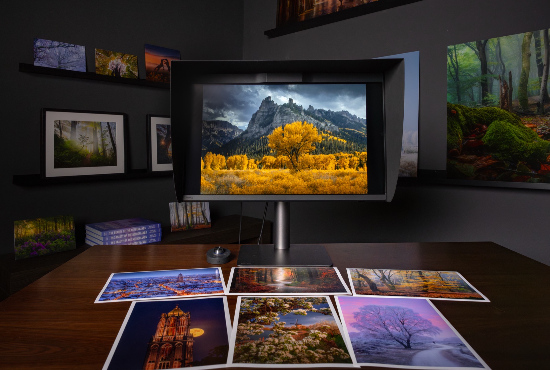 Albert's home printing setup with BenQ monitor, prints and his Beauty of the Netherlands book